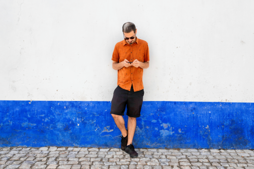full-length-young-man-standing-against-wall